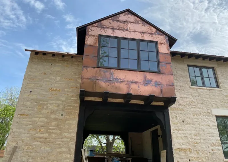Copper metal panel facade on a stone building for Roof Repair in Fairfax